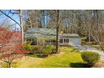 Charming single-story home with a manicured lawn, mature trees, and inviting curb appeal at 901 Emory Ln, Raleigh, NC 27609
