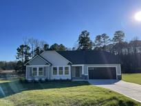 Beautiful single-story home with a well-manicured lawn, attached garage and inviting entryway at 102 Heatherglenn Cir, Princeton, NC 27569