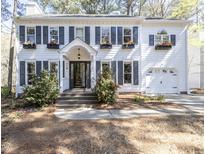 Inviting two-story home with dark shutters and blooming window boxes at 116 Lakeshore Dr, Durham, NC 27713