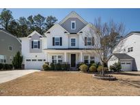Charming two-story home featuring a manicured lawn and an attached two-car garage at 117 Gravel Brook Ct, Cary, NC 27519