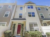 Attractive townhouse featuring a red front door and landscaped entryway at 11700 Coppergate Dr # 105, Raleigh, NC 27614