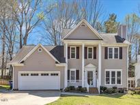 Charming two-story home with a well-manicured lawn, attached two car garage, and welcoming front porch at 3428 Singleleaf Ln, Raleigh, NC 27616