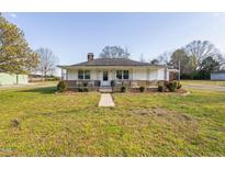 Charming one-story home with a inviting front porch, walkway, and a spacious front yard at 513 S Cheatham St, Franklinton, NC 27525