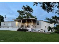 Charming single-story home with a covered front porch and well-manicured lawn at 529 Flanagan Rd, Henderson, NC 27537