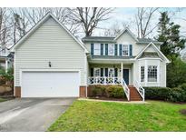 Charming two-story home with a well-maintained front yard, attached garage, and inviting curb appeal at 9724 Dansington Ct, Raleigh, NC 27615