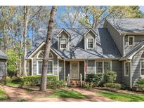 Charming home featuring a brick walkway, dormer windows, and well-maintained landscaping at 131 Long Shadow Ln, Cary, NC 27518