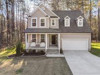 Charming two-story home with a covered front porch and well-manicured landscaping at 182 Mill Bend Dr, Fuquay Varina, NC 27526