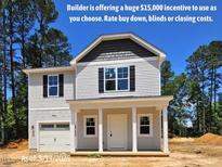 Charming two-story home with a one-car garage and a welcoming front porch at 187 Regis Ln # 10, Coats, NC 27521