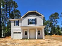 Charming two-story home with a covered porch and a one car garage at 187 Regis Ln # 10, Coats, NC 27521