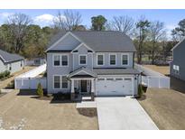 Charming two-story home with a well-manicured lawn, a two-car garage, and a welcoming front porch at 239 Hopper Cir, Clayton, NC 27520