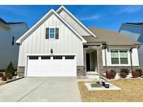 Charming home featuring stone accents, neutral siding, a well-manicured lawn and an attached two-car garage at 2918 Balbardie Dr, Apex, NC 27502