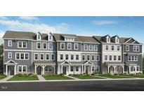 Row of newly built townhomes showing facade and design elements with professionally landscaped yards at 408 Rowe Way, Knightdale, NC 27545