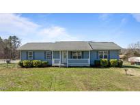 Charming single-story home featuring a cozy front porch and well-manicured lawn at 41 Rock Bluff Ln, Kittrell, NC 27544