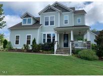 Charming two-story home with a well-manicured lawn and inviting front porch at 465 Claremont Dr, Chapel Hill, NC 27516