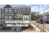 Charming townhome with stone accents, gray siding, and well-maintained landscaping at 5200 Invention Way, Raleigh, NC 27616