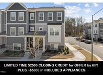 Charming gray townhome with manicured landscaping and inviting entryway at 5200 Invention Way, Raleigh, NC 27616