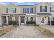 Charming townhouse with a stone facade and covered entrance to provide an inviting curb appeal at 5340 Big Bass Dr, Raleigh, NC 27610