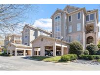 Exterior view of the condo building with well-maintained landscaping and brick carports at 542 W Barbee Chapel Rd # Bldg 500, Chapel Hill, NC 27517