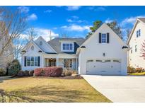 Charming two-story white brick home with a well-manicured lawn and attached two-car garage at 5725 Lord Granville Way, Rolesville, NC 27571