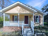 Charming one-story home with a quaint front porch and white railing offers great curb appeal at 610 Shepard School Rd, Zebulon, NC 27597