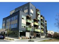 Modern apartment building featuring multi-story design, balconies, and street-level entrance on a clear day at 610 Trent Dr # 202, Durham, NC 27705