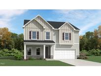 Charming two-story home with gray siding, stone accents, and a welcoming front porch at 1004 Red Roses Ave, Durham, NC 27703