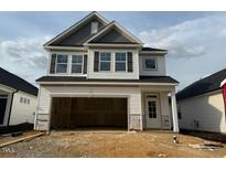 New construction two story home with attached garage and neutral color palette at 104 Fairwinds Dr, Lillington, NC 27546