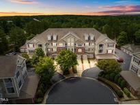 Stunning aerial view of a multi-Gathering home with lush landscaping and a circular driveway at sunset at 10400 Rosegate Ct # 3, Raleigh, NC 27617