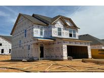 Two-story home under construction showcasing a modern design with a covered porch and attached garage at 1049 Channel Drop Lp, Zebulon, NC 27597