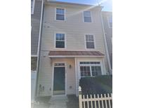 Charming townhome featuring a quaint covered entrance and well-maintained front yard at 11711 Mezzanine Dr # 109, Raleigh, NC 27614