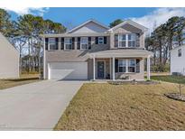 Charming two-story home with gray brick facade, a well-manicured lawn, and attached two-car garage at 1253 Manor Dr, Rocky Mount, NC 27804