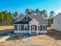 Charming single-story home featuring a classic gray exterior and a welcoming front porch at 195 Duncan Creek Rd # 123, Lillington, NC 27546