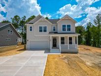 Charming two-story home featuring a covered porch and an attached two-car garage at 217 Duncan Creek Rd # 124, Lillington, NC 27546