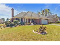 Charming brick home with well-manicured lawn, front porch and view of pond at 248 Brookfield Cir, Sanford, NC 27330