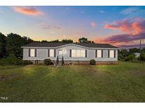 Charming single-story home with well-maintained lawn and classic curb appeal at 2751 Old Fairground Rd, Angier, NC 27501