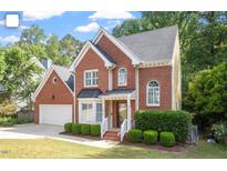 Beautiful brick two-story home with manicured lawn, elegant windows, and attached two car garage at 2812 Dahlgreen Rd, Raleigh, NC 27615