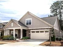 Charming single-Gathering home with a well-manicured lawn and a two-car garage and stone details at 3009 Kildaire Dairy Way, Apex, NC 27539