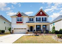 Charming two-story home with red and white accents, landscaped yard, and a two-car garage at 3557 S Beaver Ln, Raleigh, NC 27604