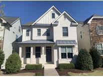 Charming white two-story home with manicured landscaping and a covered front porch at 4026 Overcup Oak Ln, Cary, NC 27519