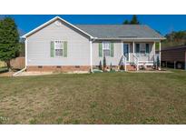 Charming single-story home with a cozy front porch and well-maintained landscaping at 46 Trawick Pl, Clayton, NC 27520