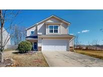 Inviting two-story home with a two-car garage, light siding, and a manicured front lawn at 507 Southwick Pl, Mebane, NC 27302