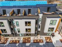 Modern townhomes with metal roofs, rooftop patios, and contemporary landscaping at 512 Gordon St # 404, Durham, NC 27701
