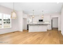 Bright kitchen features a large island, white cabinets, and modern stainless steel appliances at 55 Glasgow, Rocky Mount, NC 27804