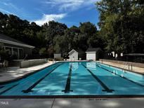 Inviting swimming pool with lane markers and clear blue water, surrounded by lush greenery, perfect for relaxation at 5932 Whitebud Dr, Raleigh, NC 27609