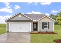 Charming one-story home with a two-car garage, gray siding and a well-manicured lawn at 65 Crow Field St, Roxboro, NC 27574