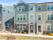 Charming townhome showcasing a well-manicured lawn and inviting covered entrance at 6926 Leesville Rd, Raleigh, NC 27613