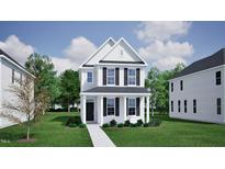 Charming two-story white home with black shutters and a well-manicured lawn on a sunny day at 728 Georgia'S Landing Pkwy # 9, Raleigh, NC 27603