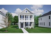Charming two-story home featuring a welcoming front porch and classic architectural details at 732 Georgia'S Landing Pkwy # 8, Raleigh, NC 27603