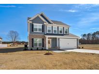 Charming two-story home featuring a two-car garage, and manicured lawn at 75 Eltham, Rocky Mount, NC 27804