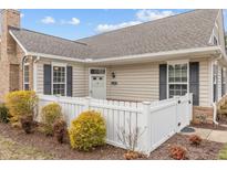 Inviting single-story home featuring a manicured front yard with a charming white picket fence at 1159 Blue Bird Ln, Wake Forest, NC 27587